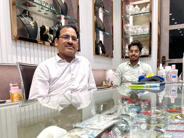 Staff at the glass counter with gemstone and bracelet display